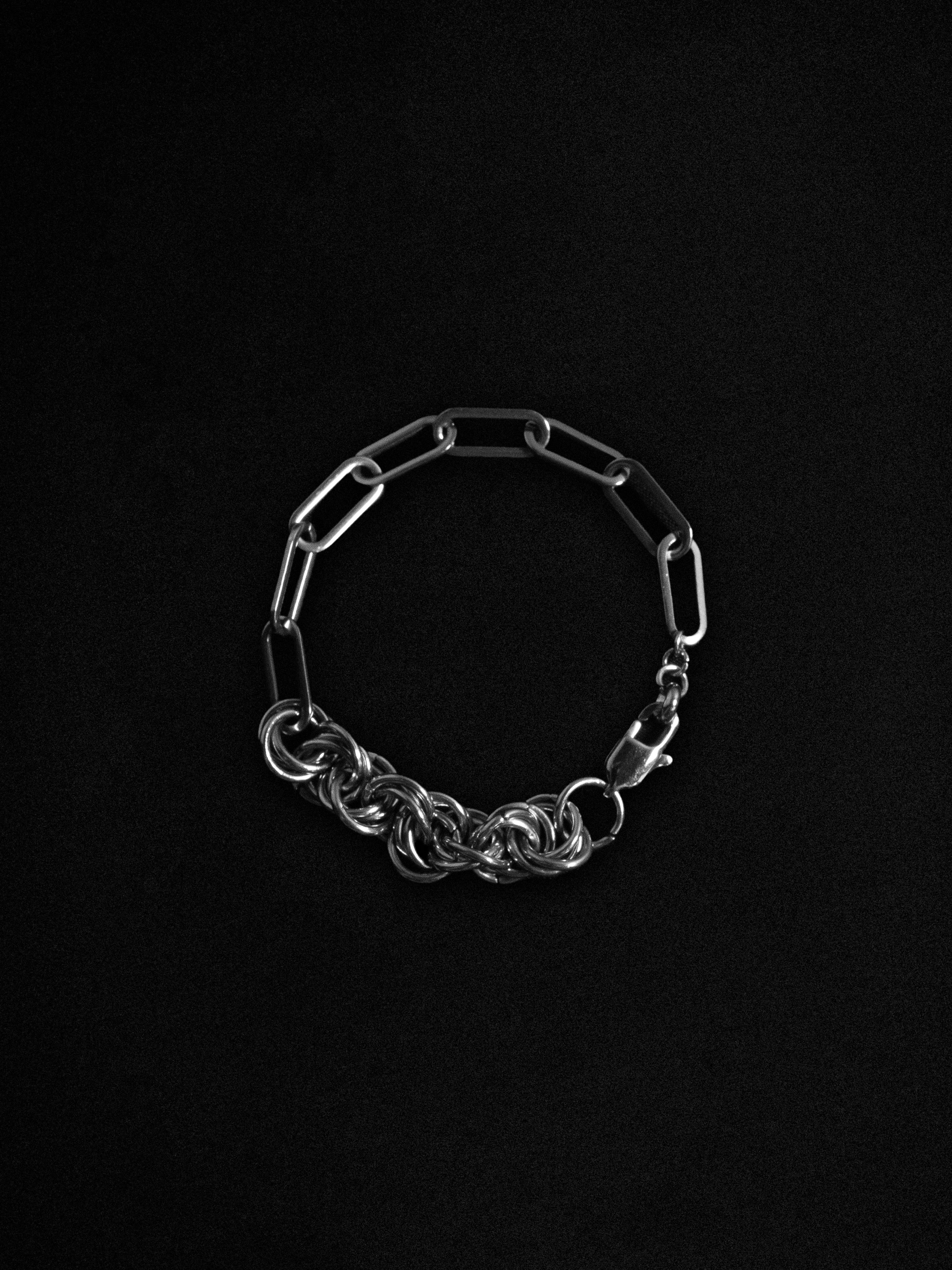 Silver chain bracelet on a black background