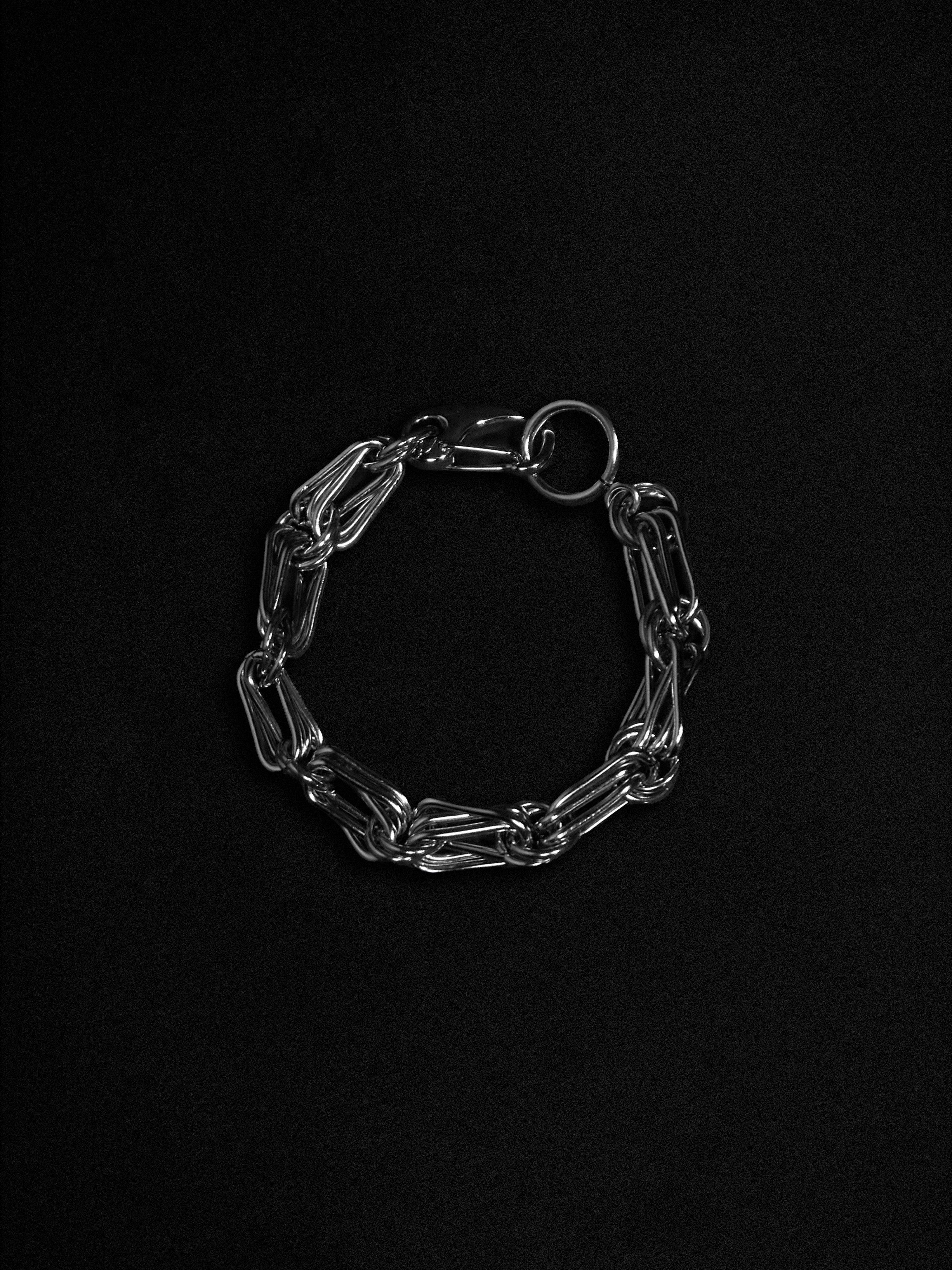 Silver chain bracelet on a black background