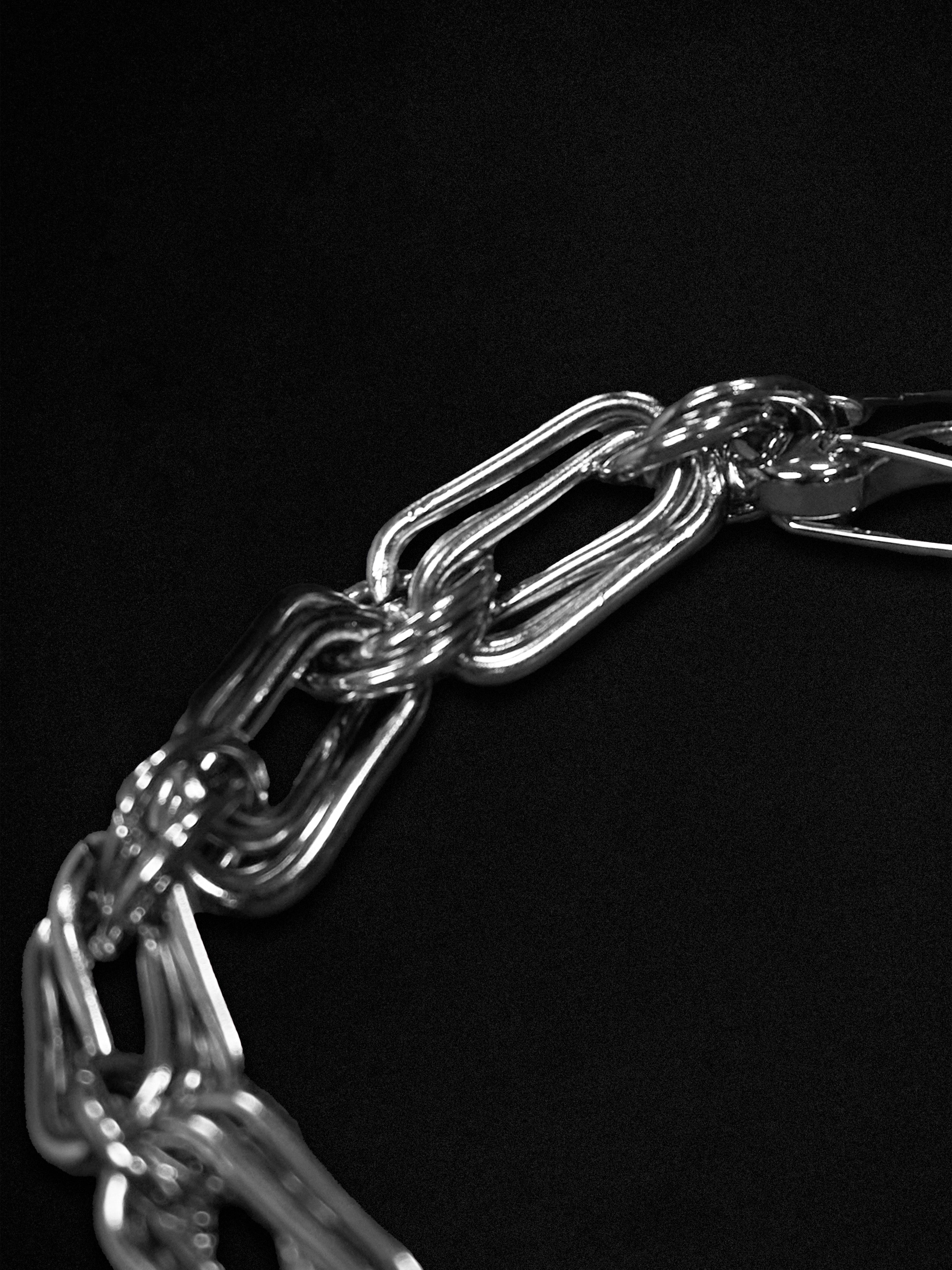 Close-up of a silver chain on a black background