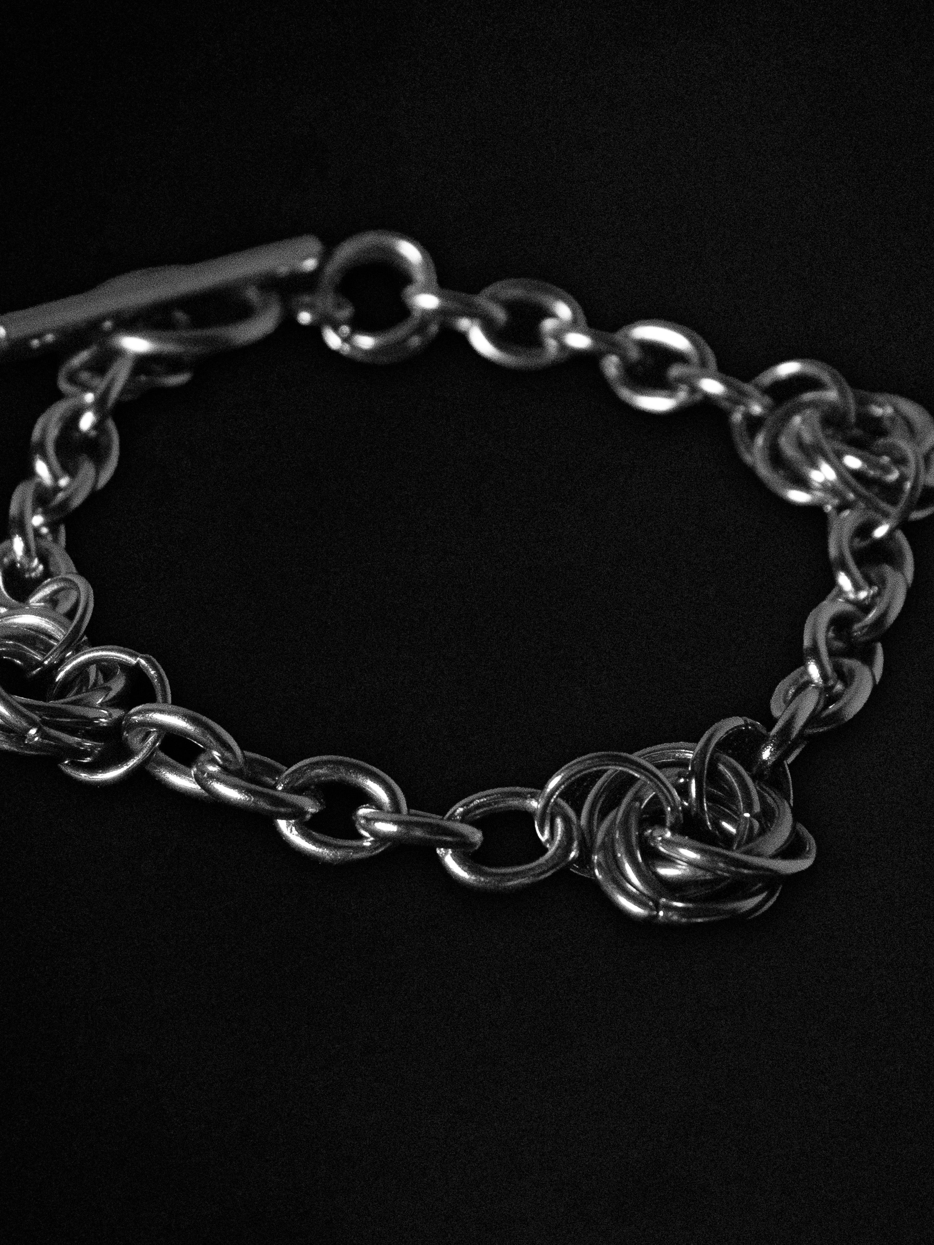 Silver chain bracelet on a black background
