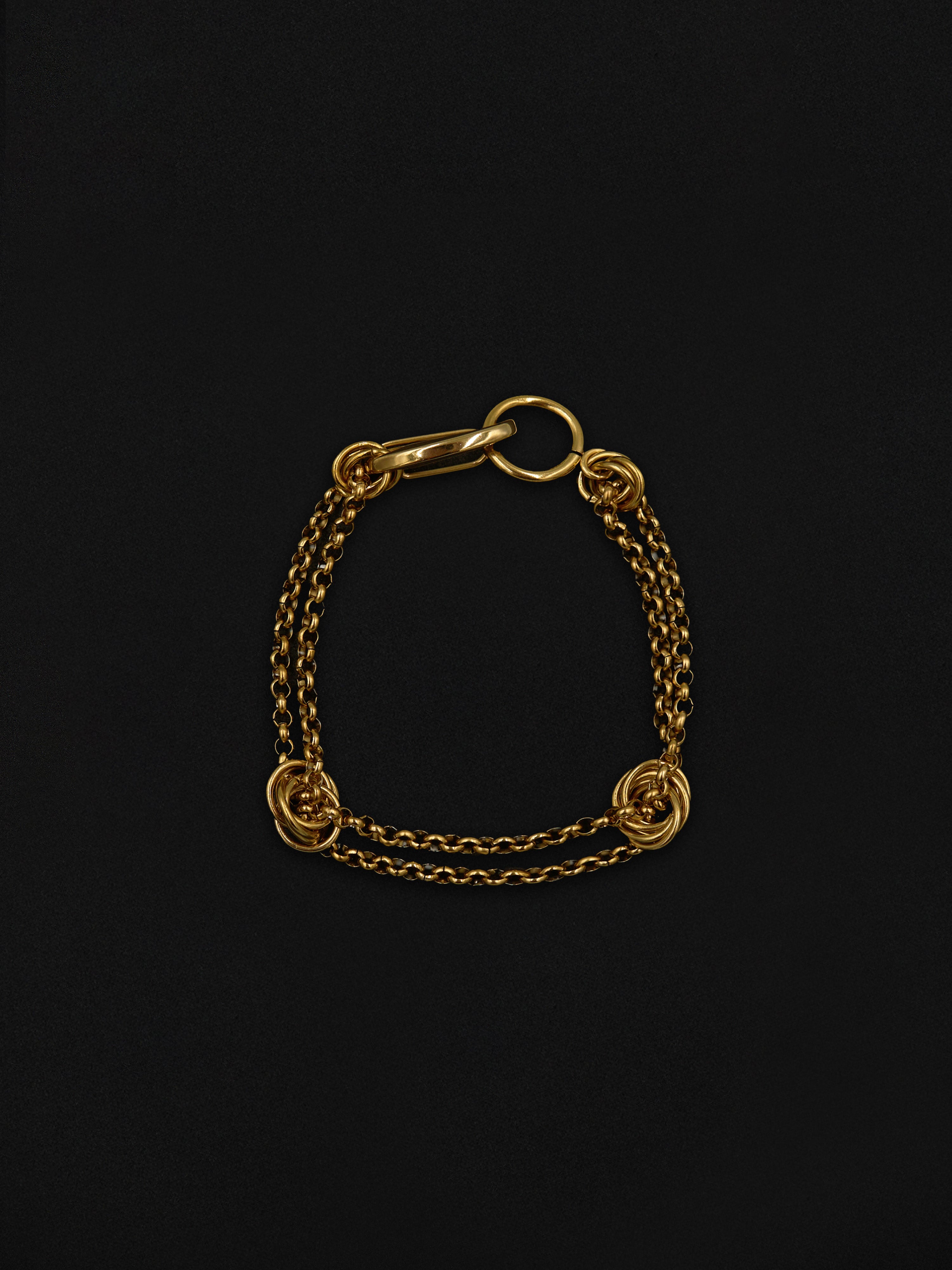 Gold chain bracelet on a black background