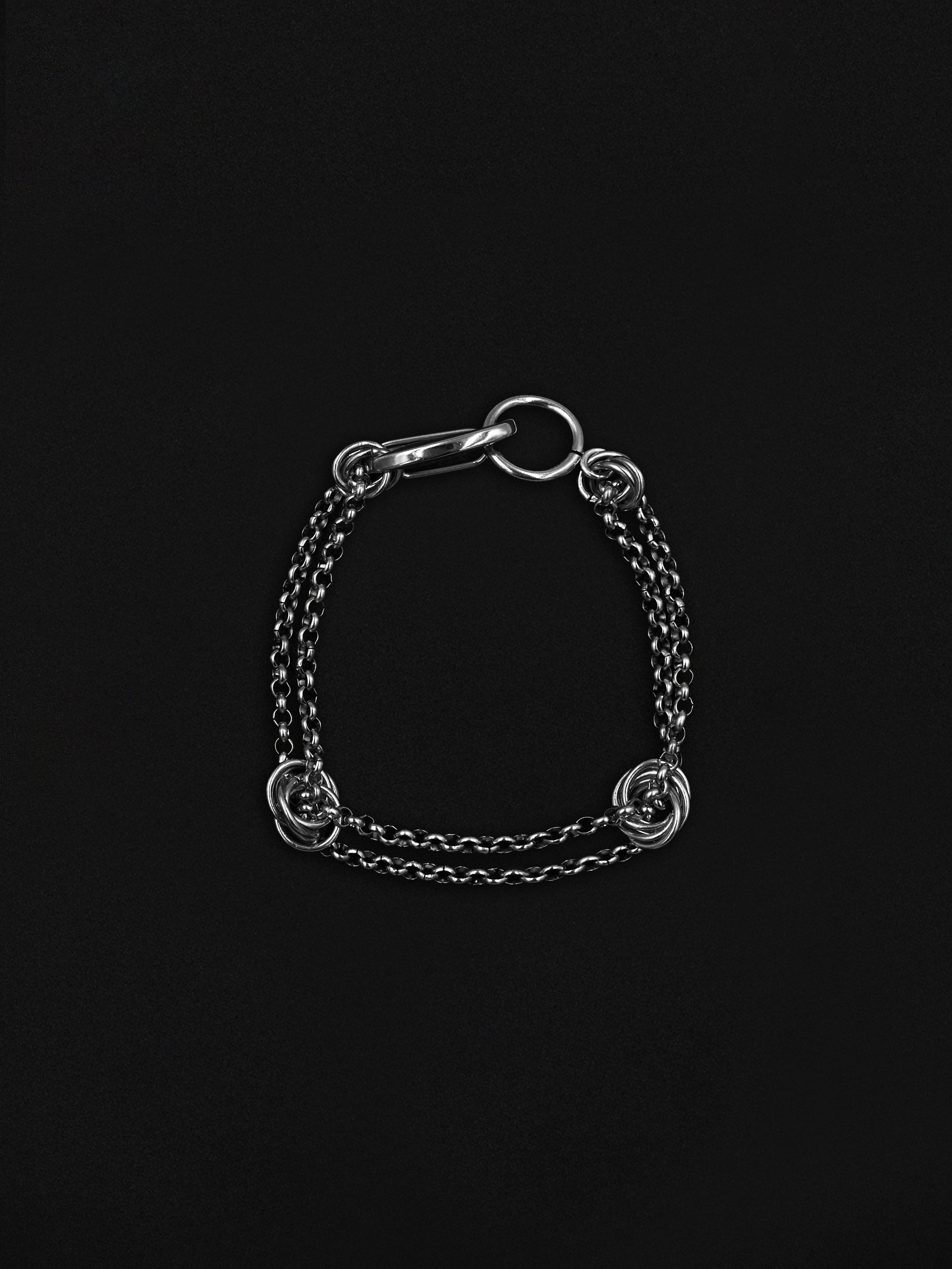 Silver chain bracelet on a black background