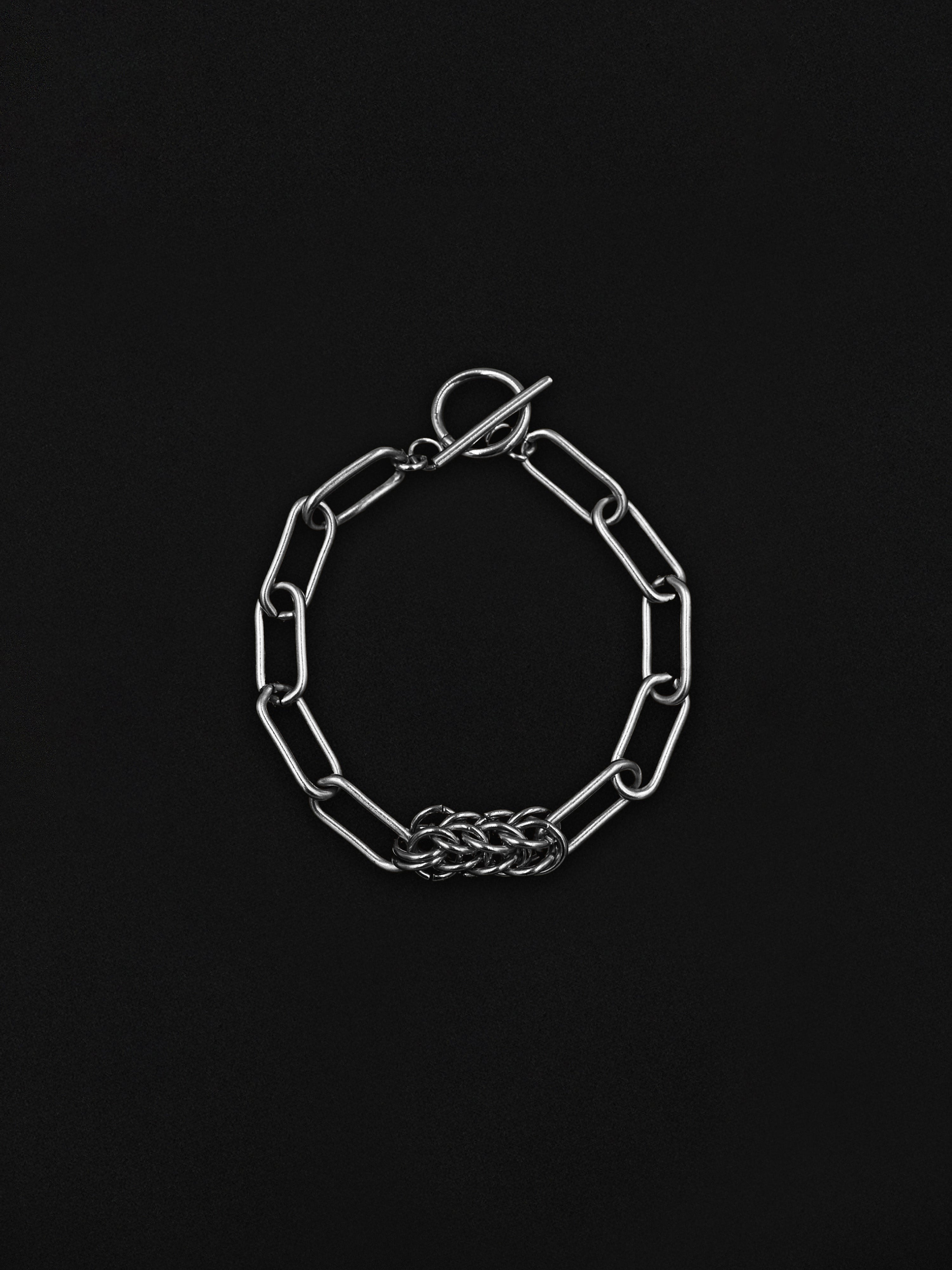 Silver chain bracelet on a black background