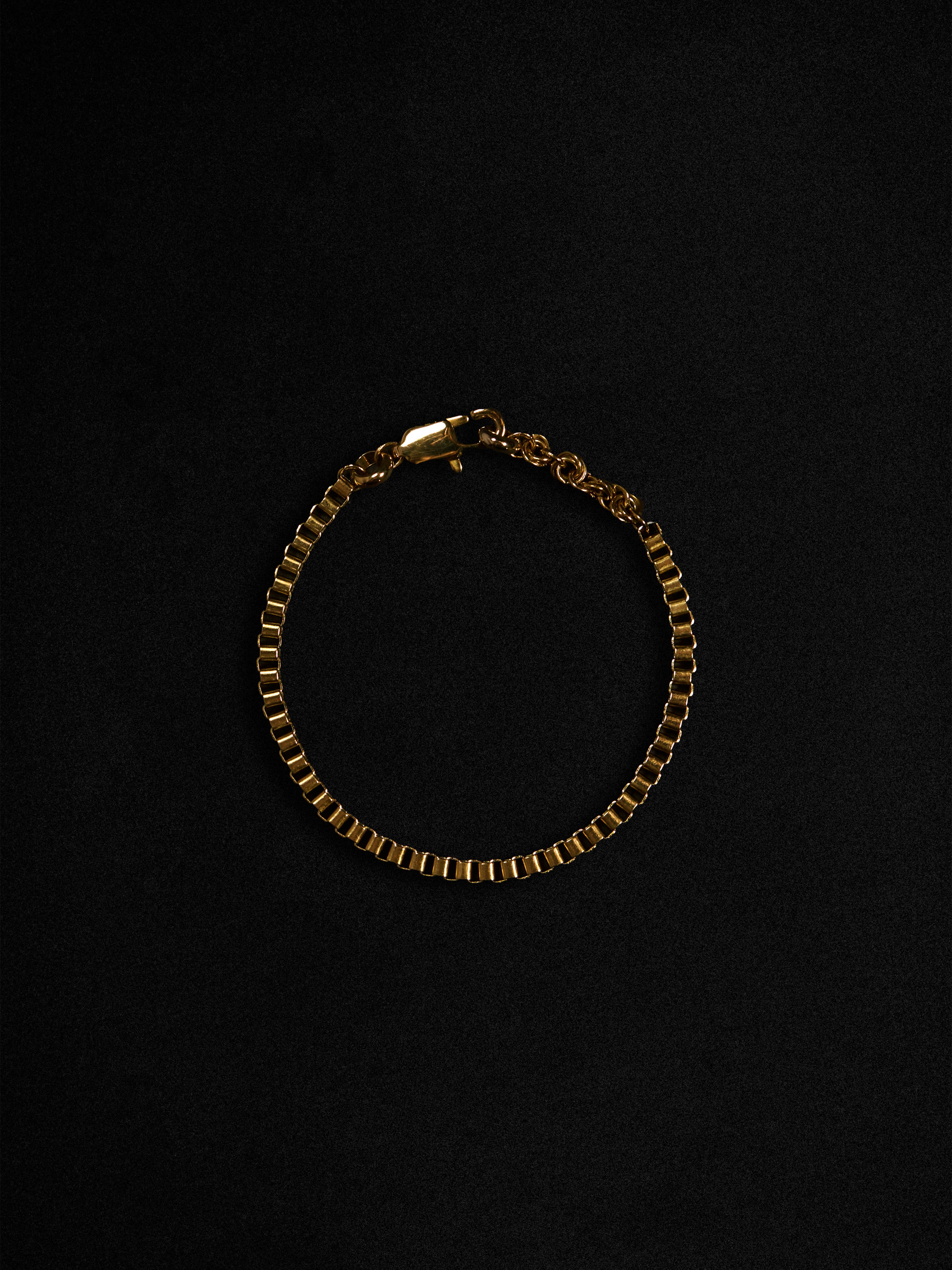 Gold bracelet on a black background