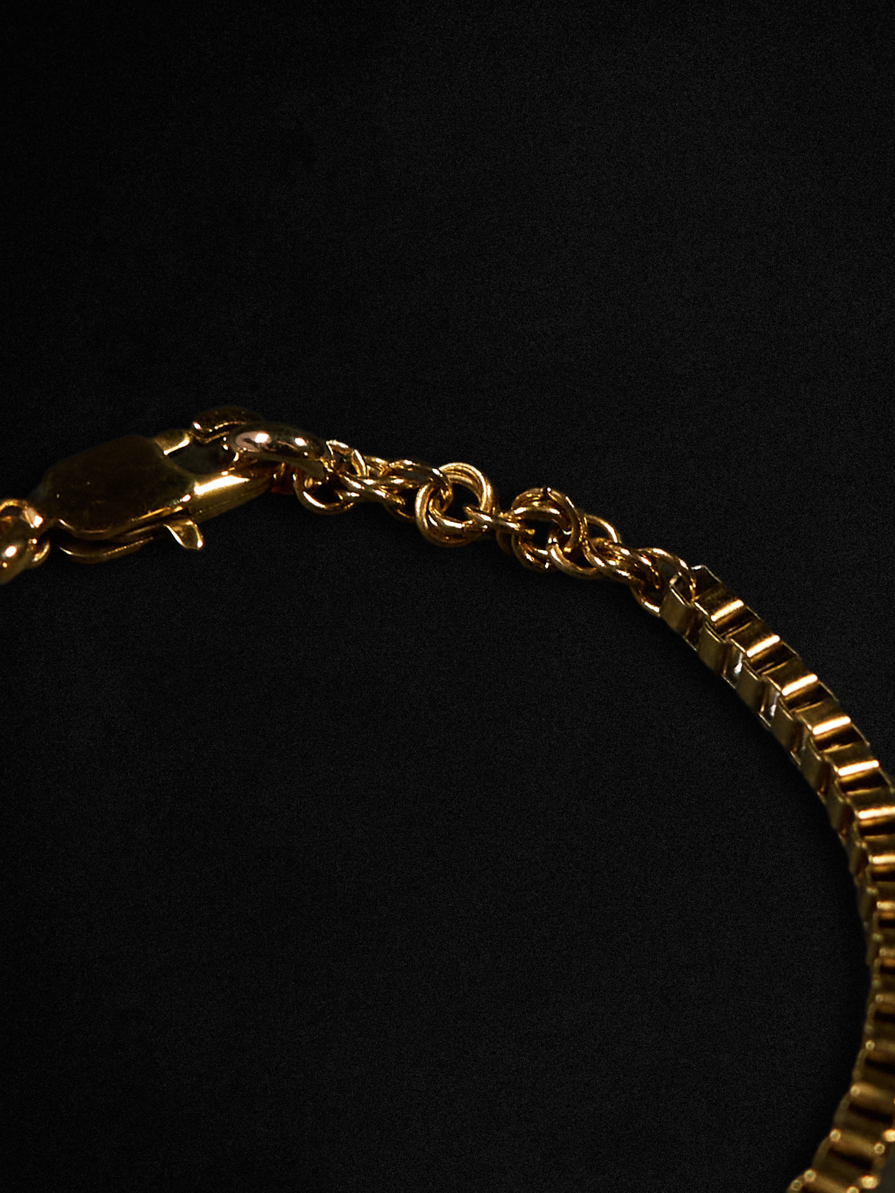 Gold bracelet on a black background