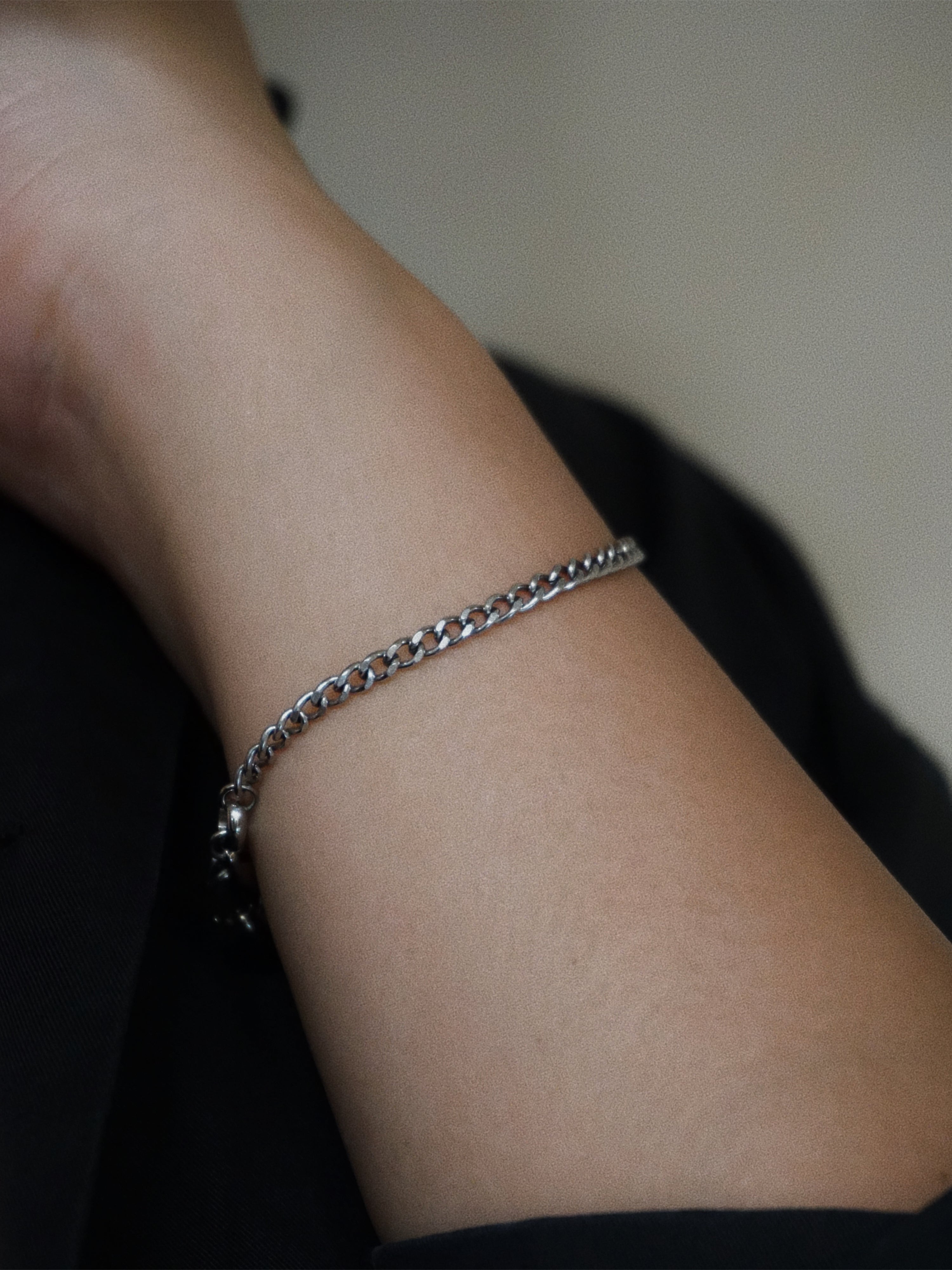 Silver bracelet on a wrist with a blurred background