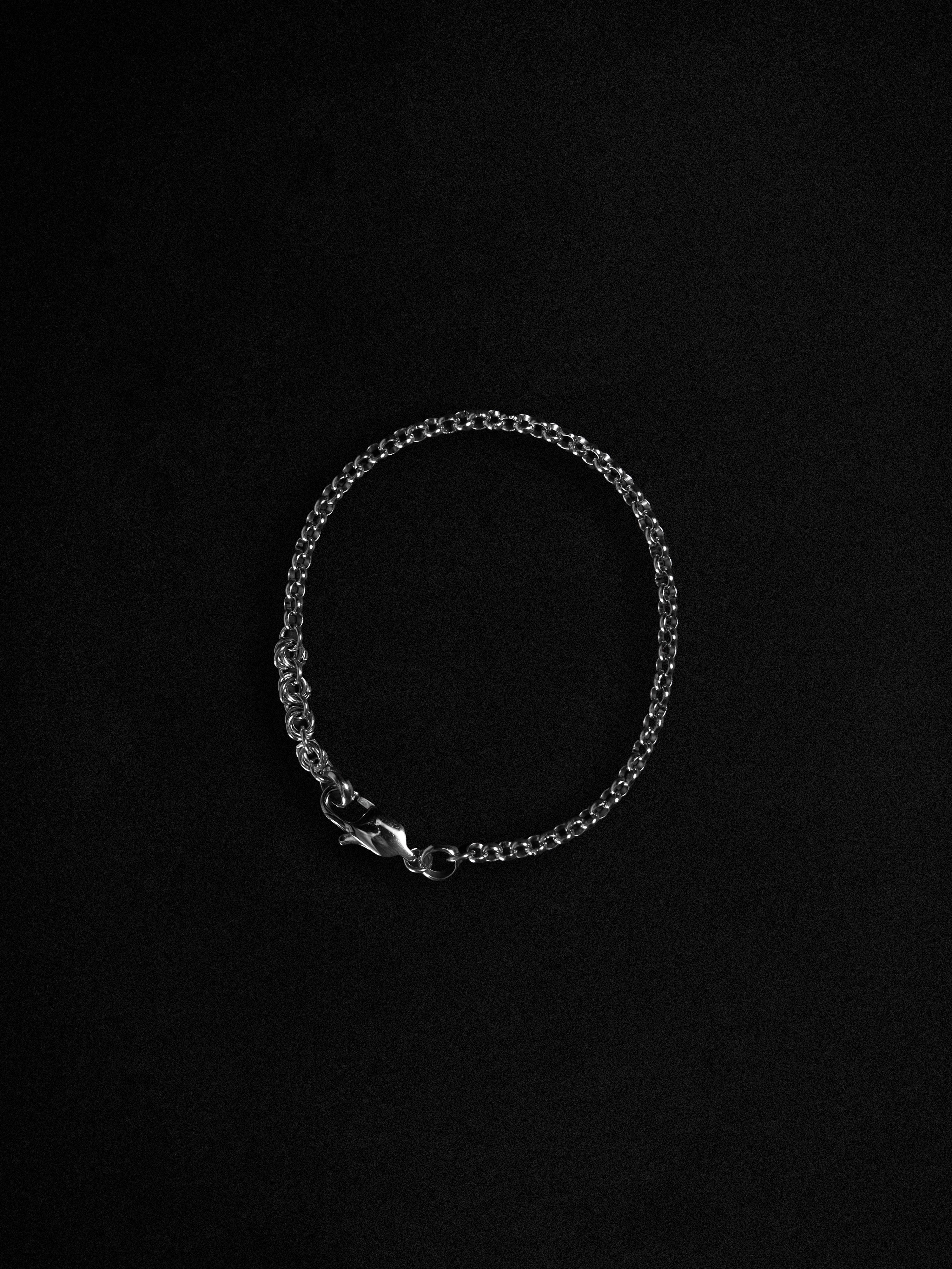 Silver bracelet on a black background