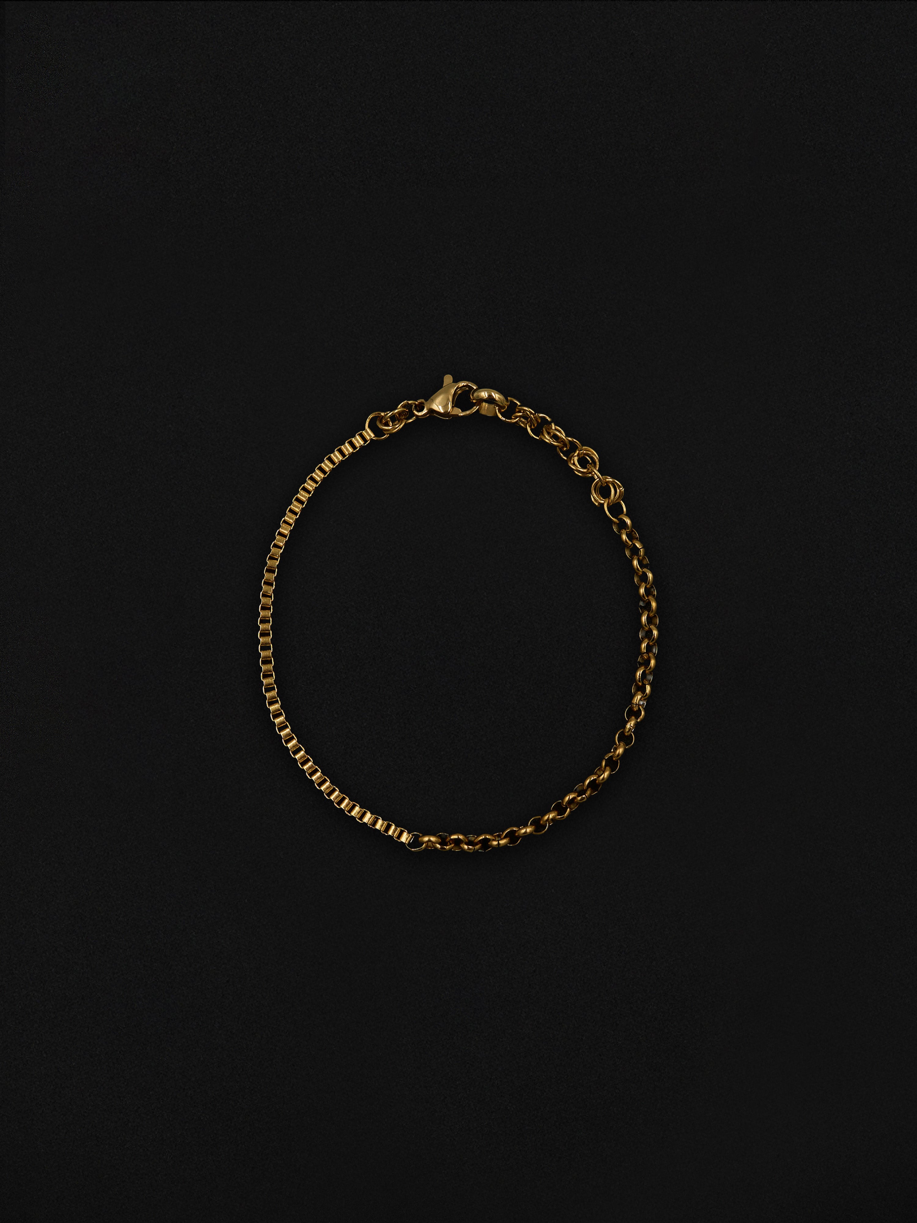 Gold chain bracelet on a black background