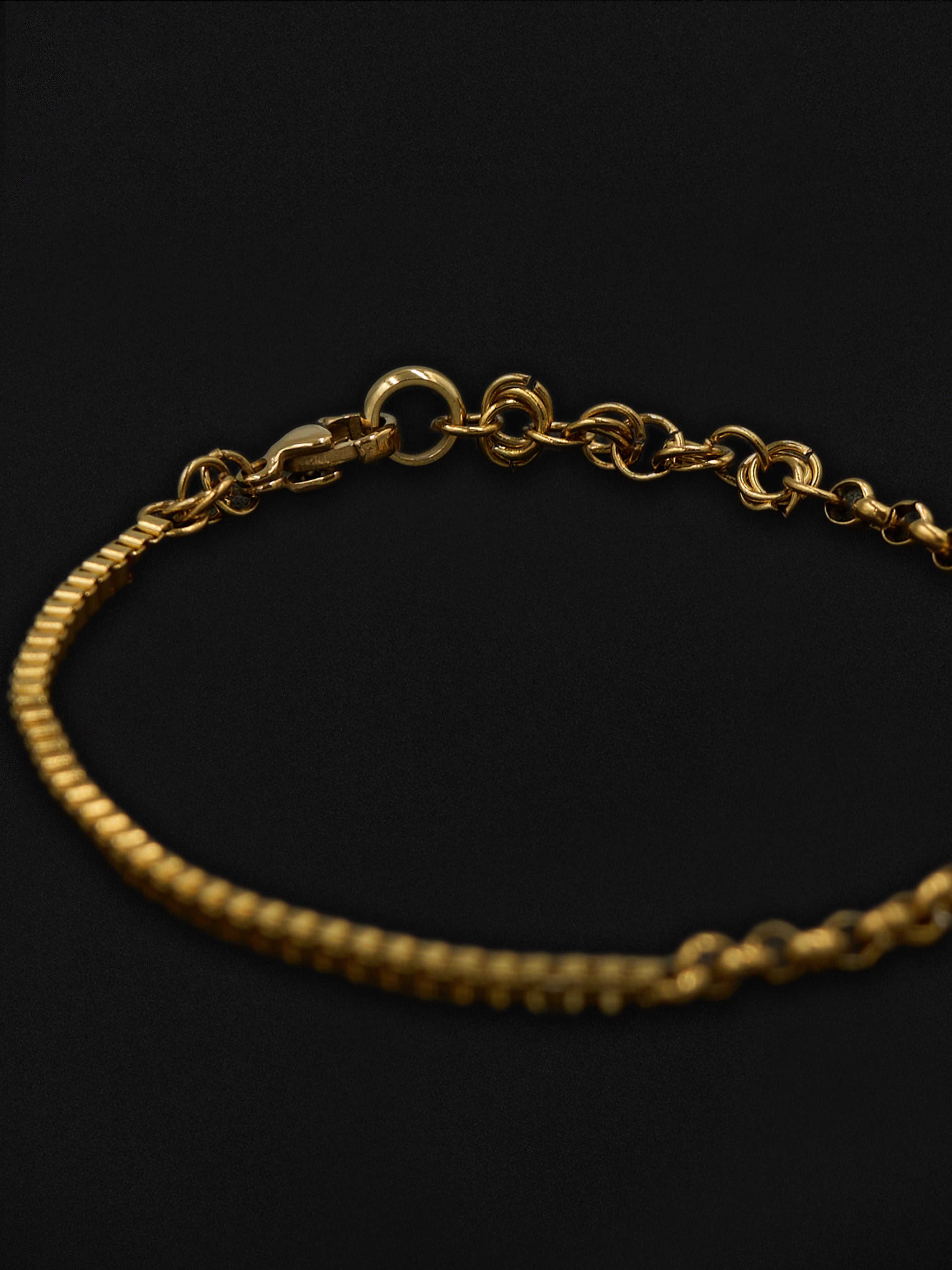 Gold chain bracelet on a black background