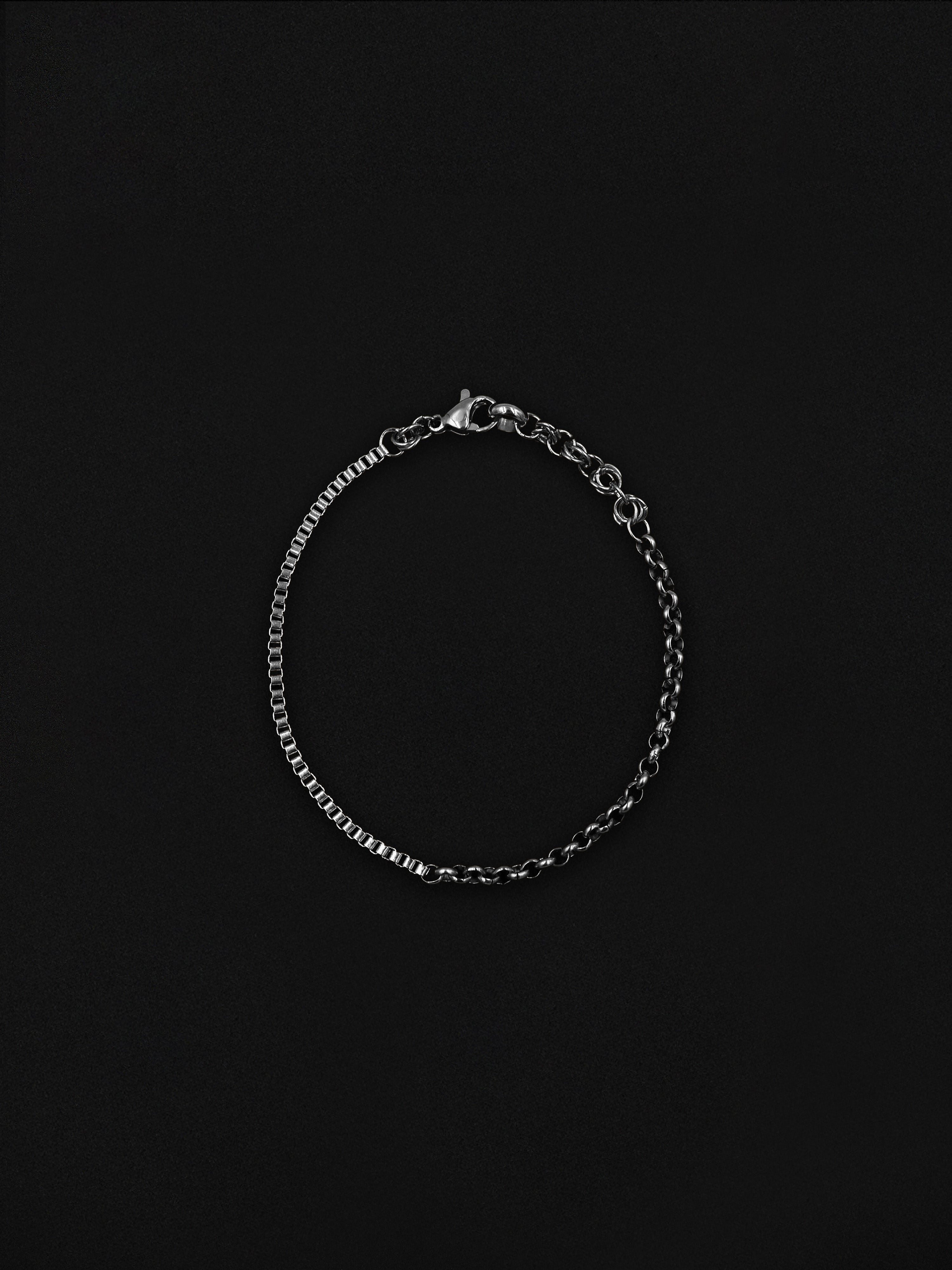 Silver chain bracelet on a black background