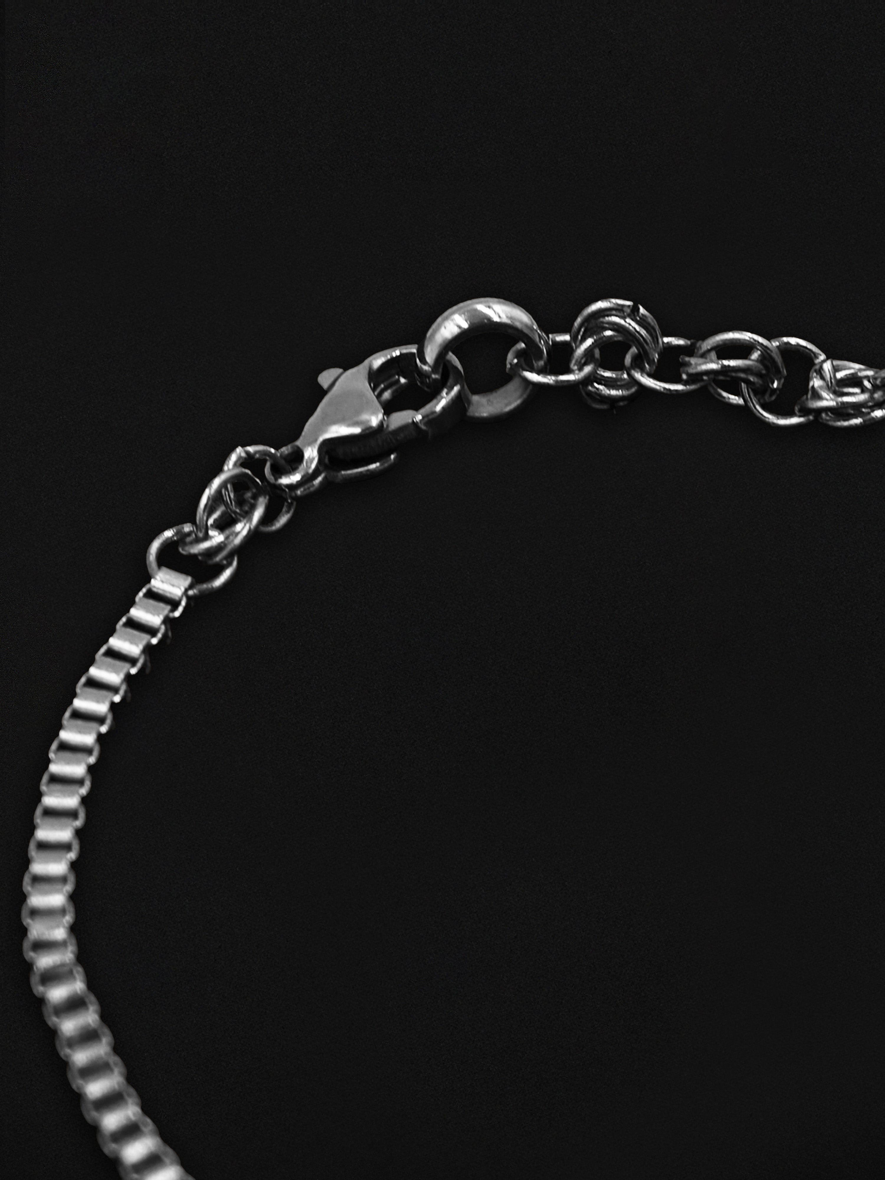 Silver chain bracelet on a black background