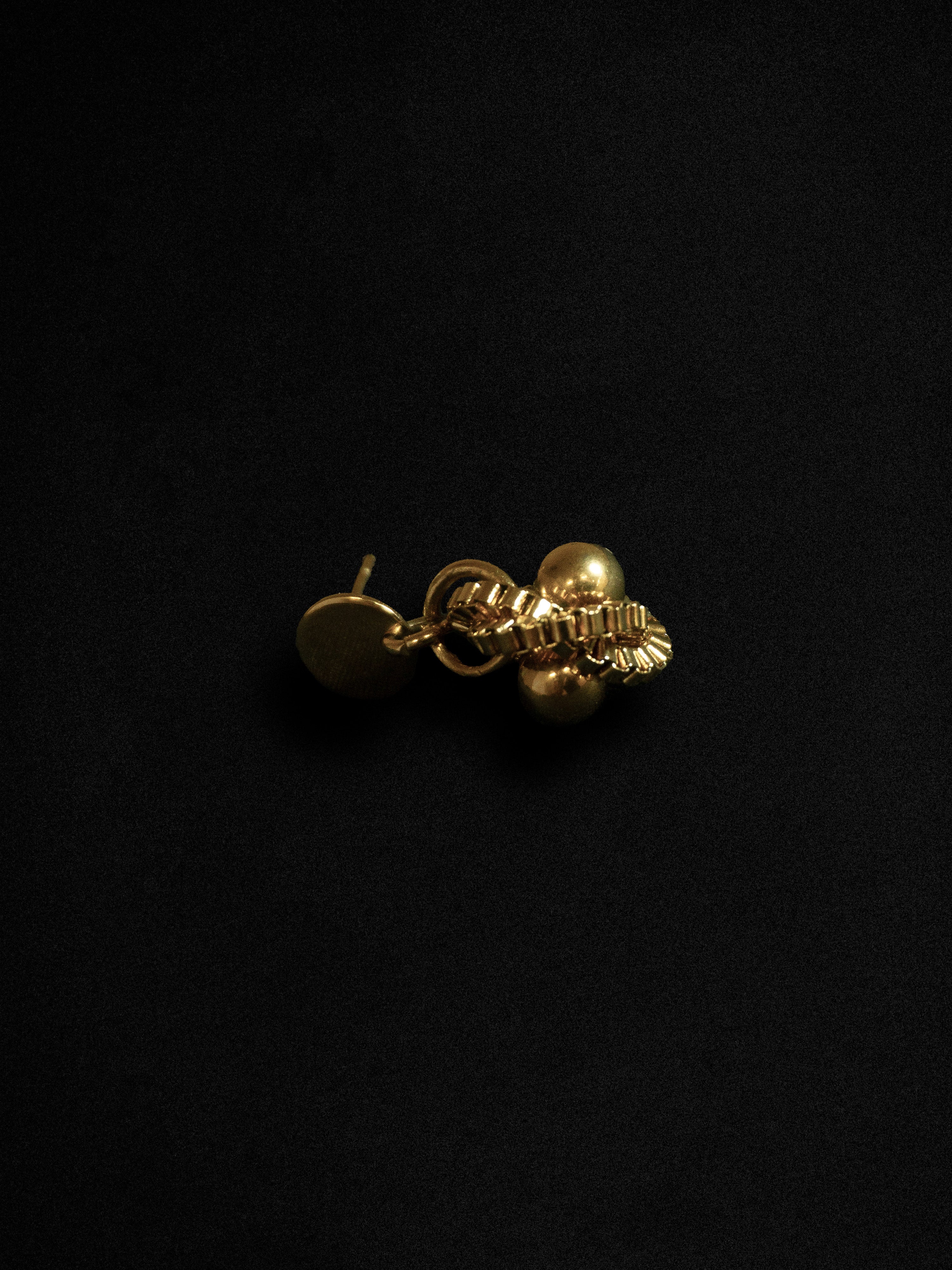 Gold earring on a black background