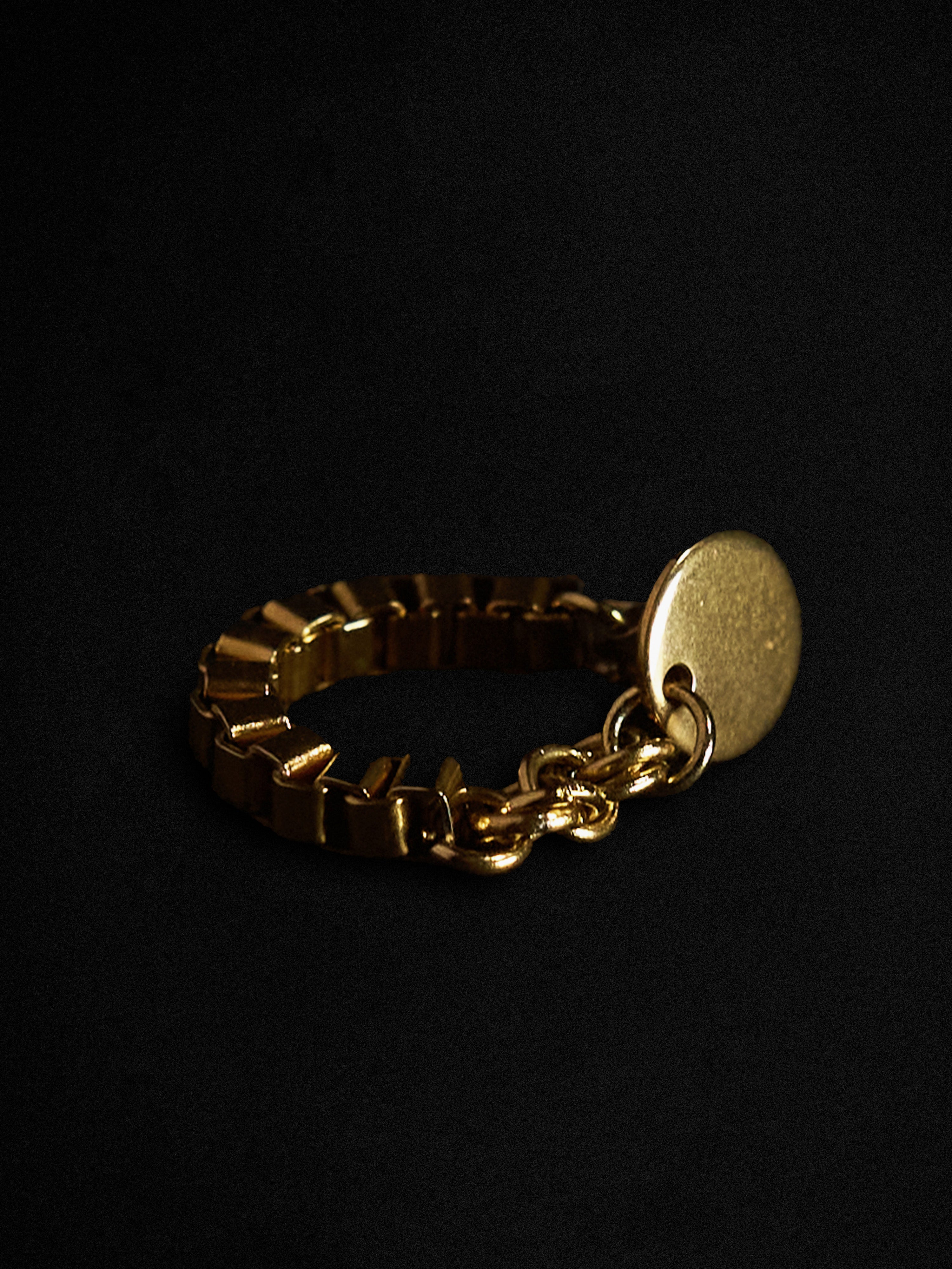 Gold chain earring on a black background