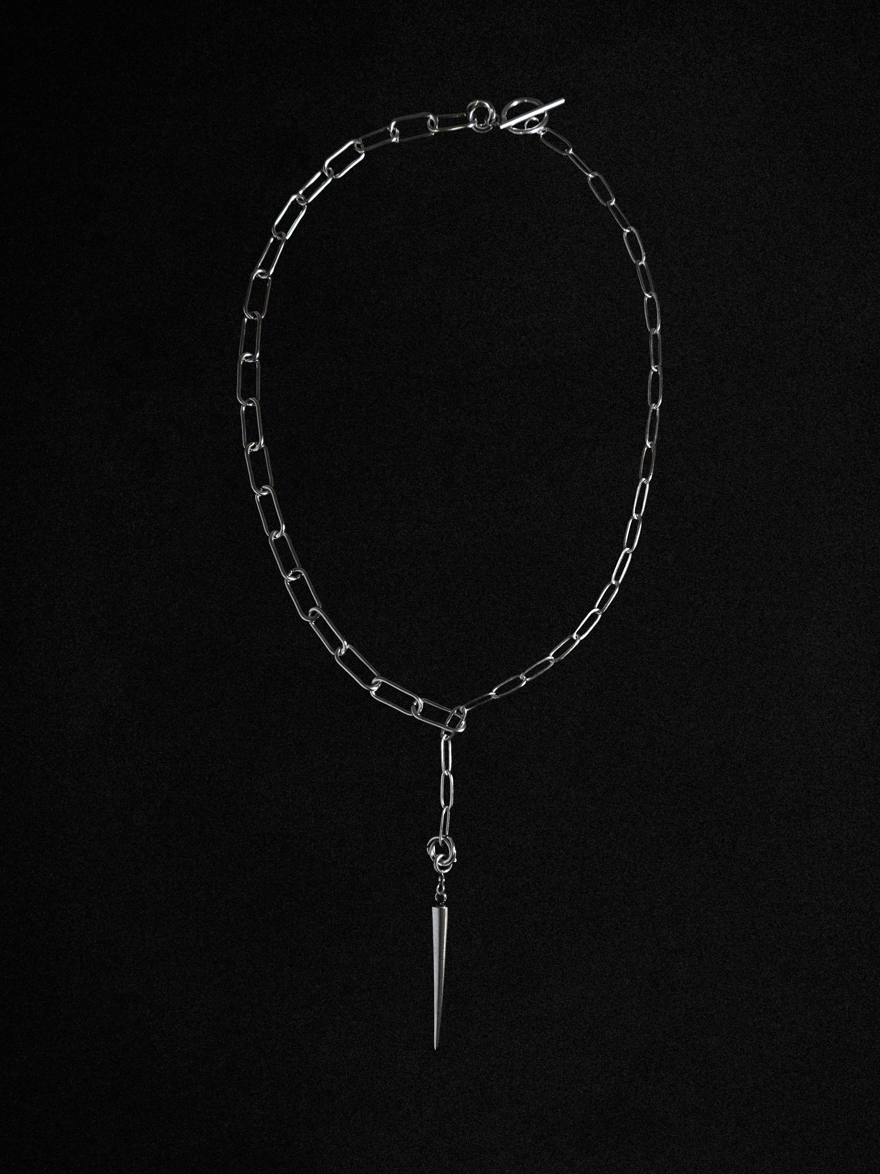 A silver necklace with a pine cone pendant on a black background.