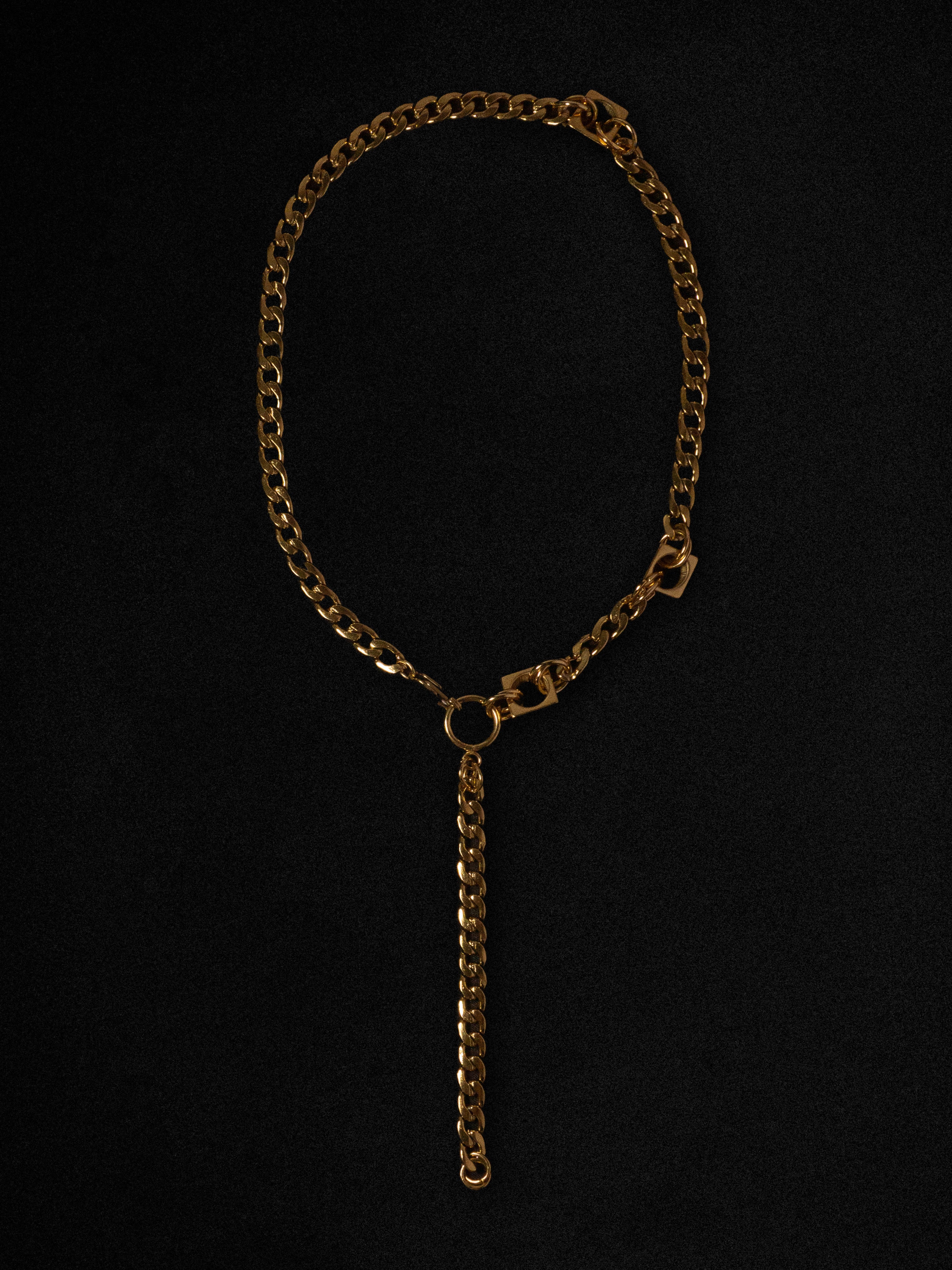 Gold chain necklace on a black background