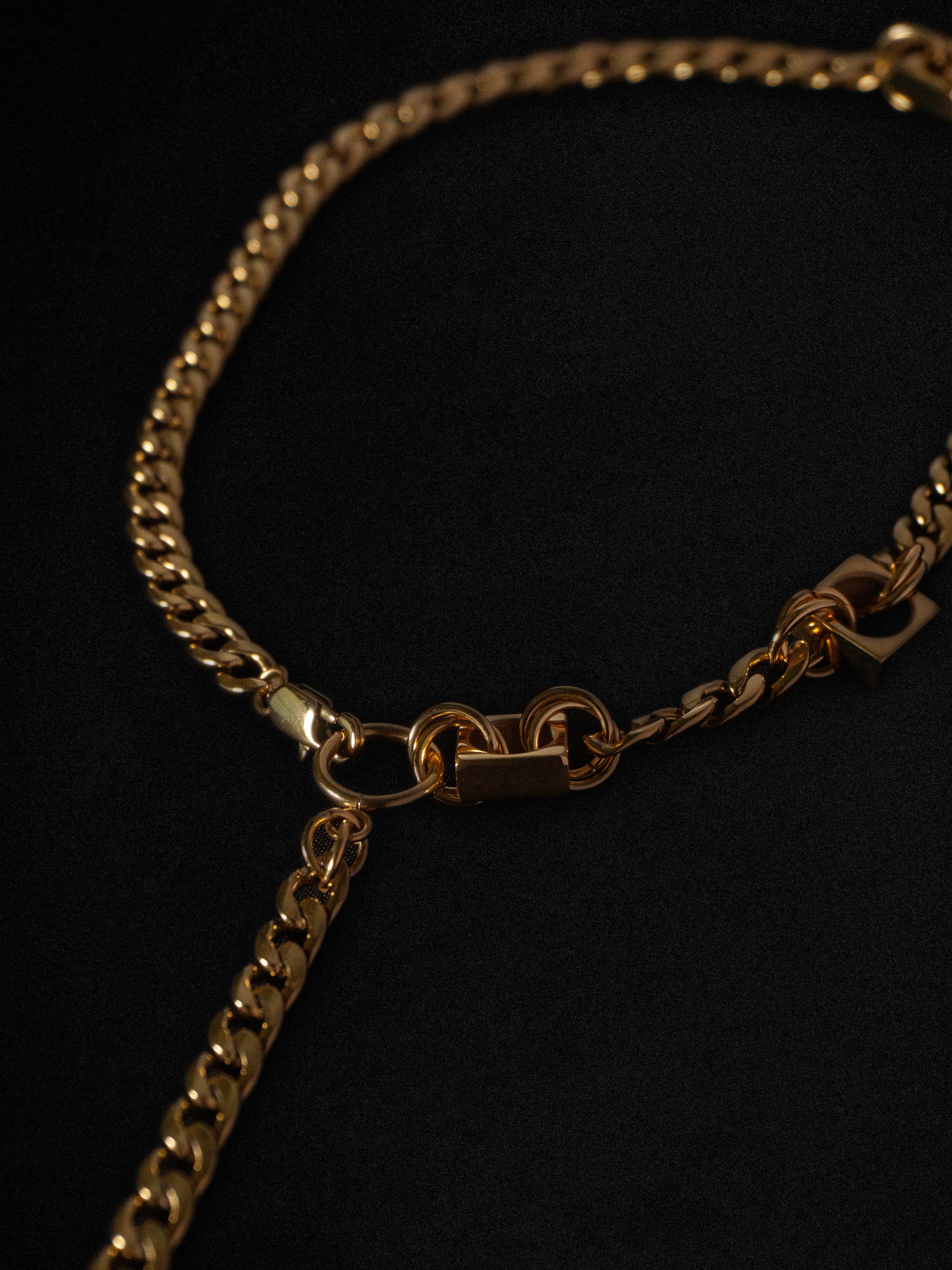 Gold chain necklace on a black background