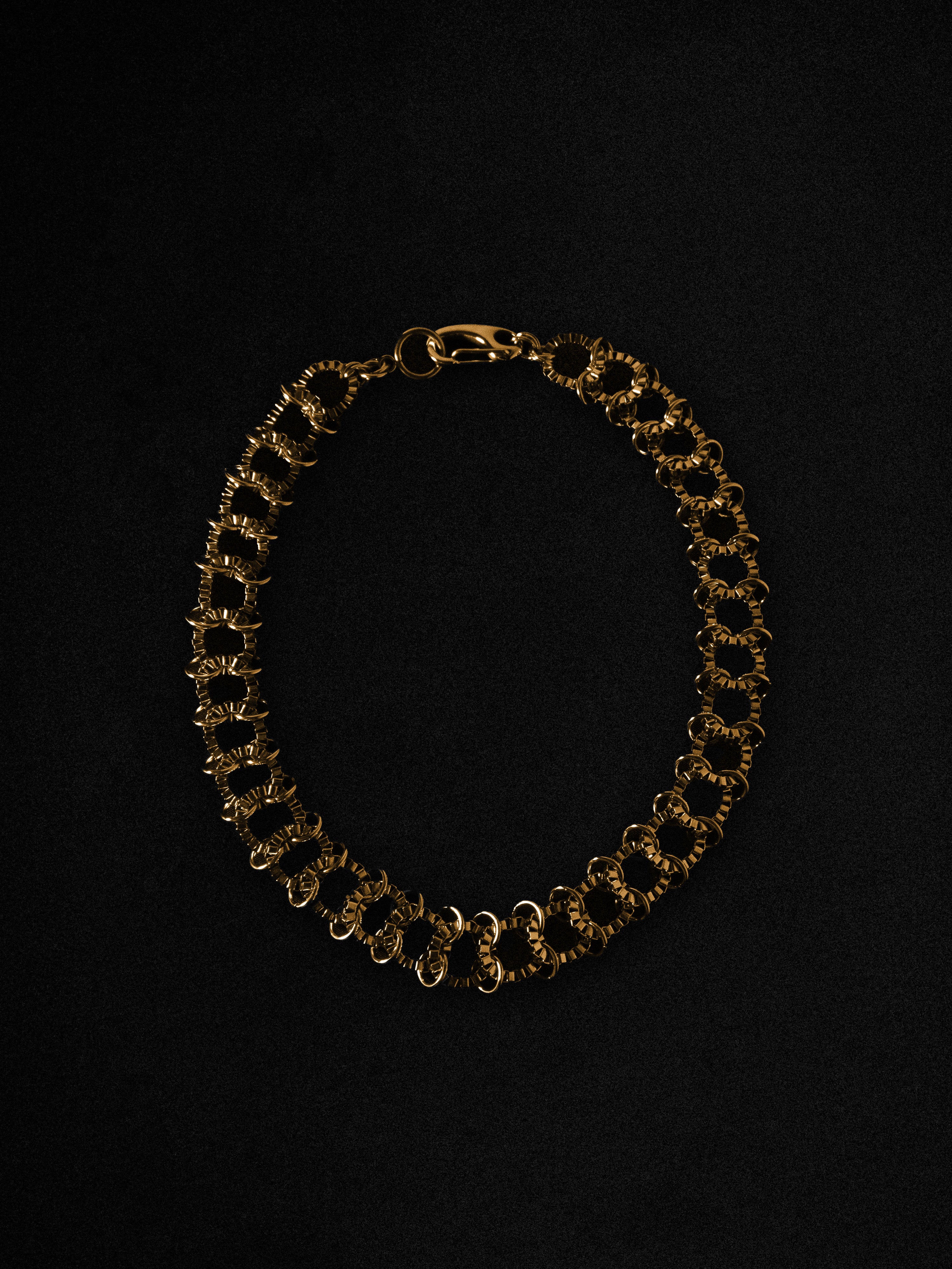 Gold chain necklace on a black background