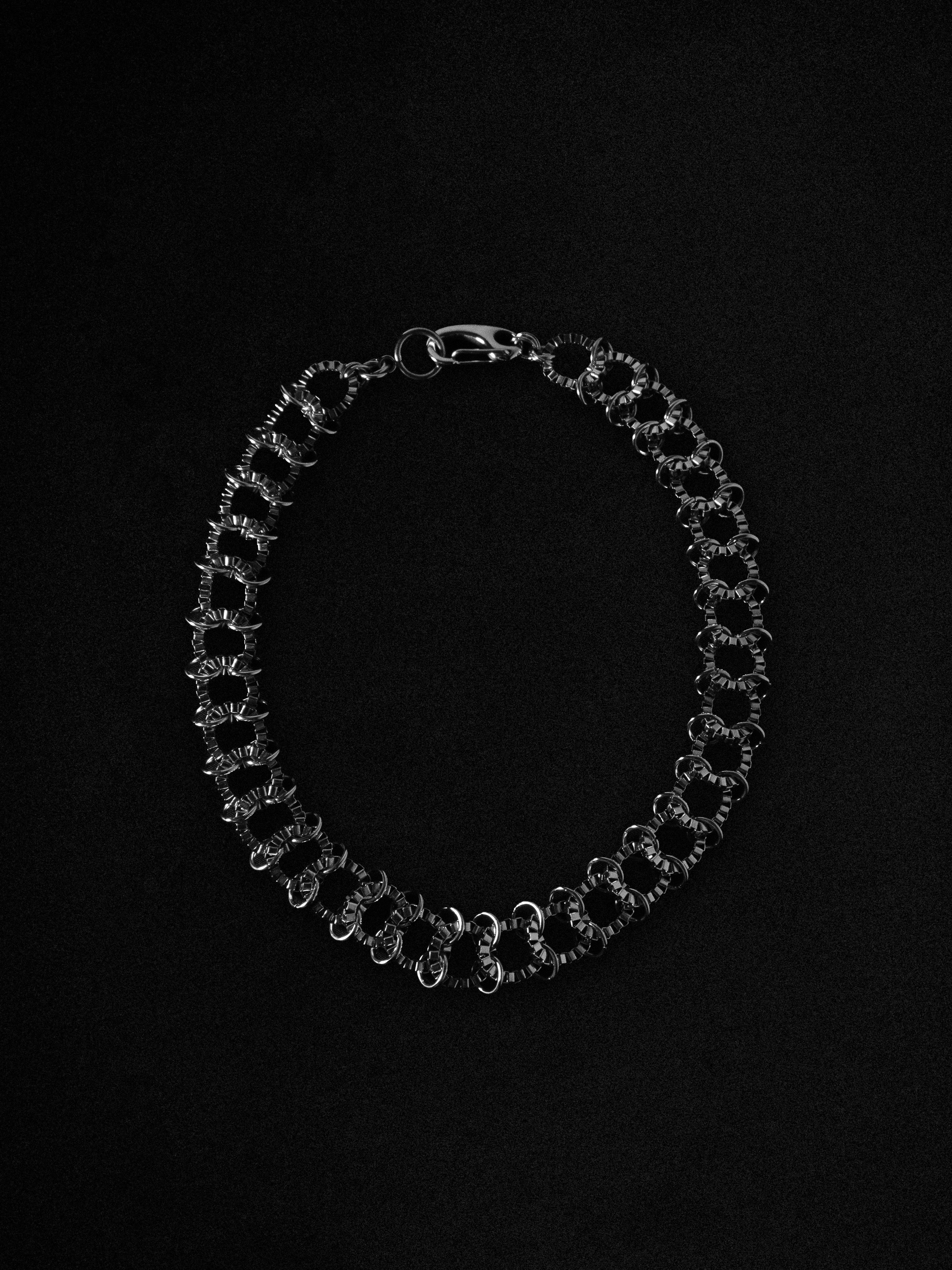 Silver chain necklace on a black background