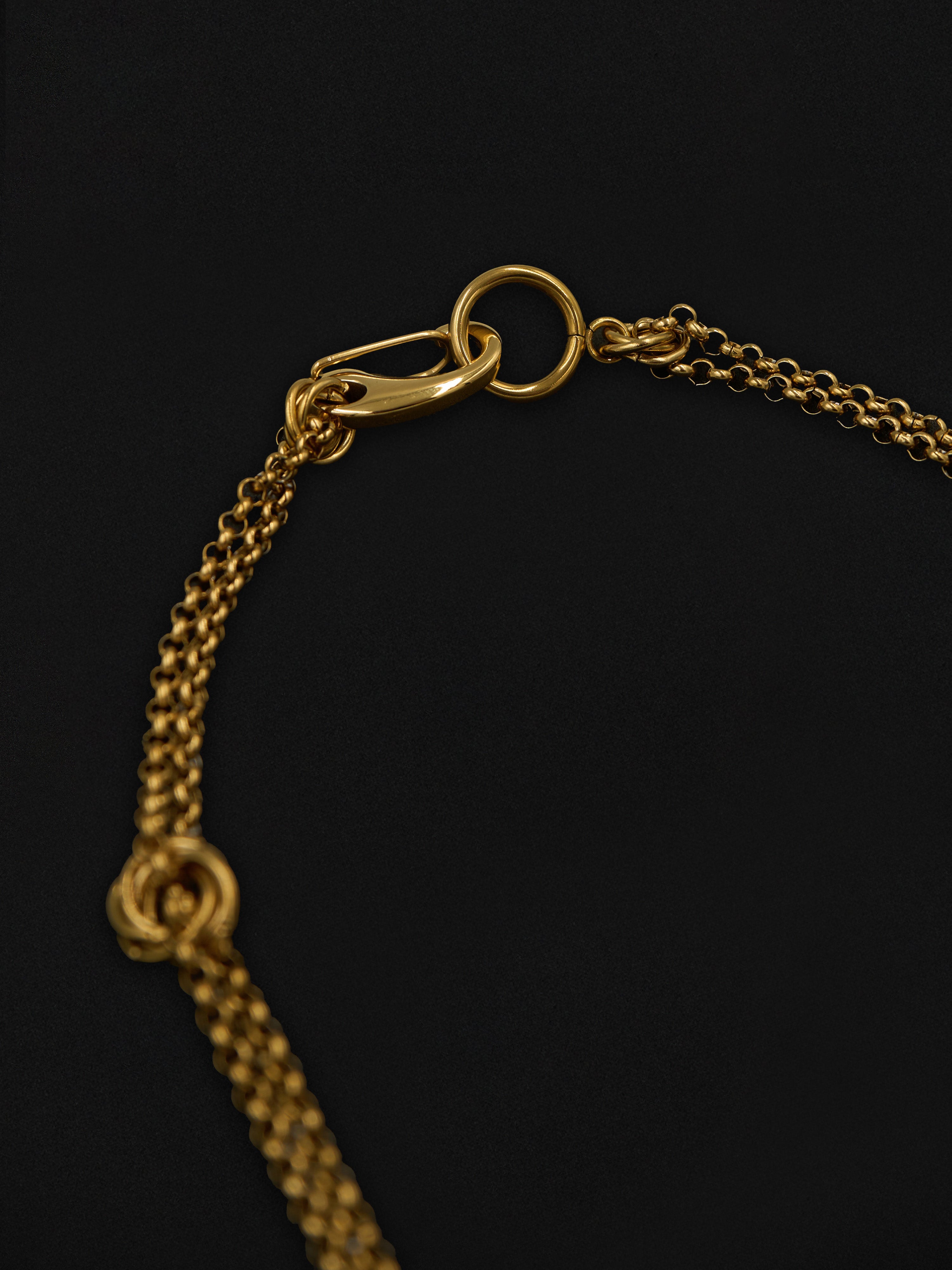 Close of a gold chain necklace on a black background