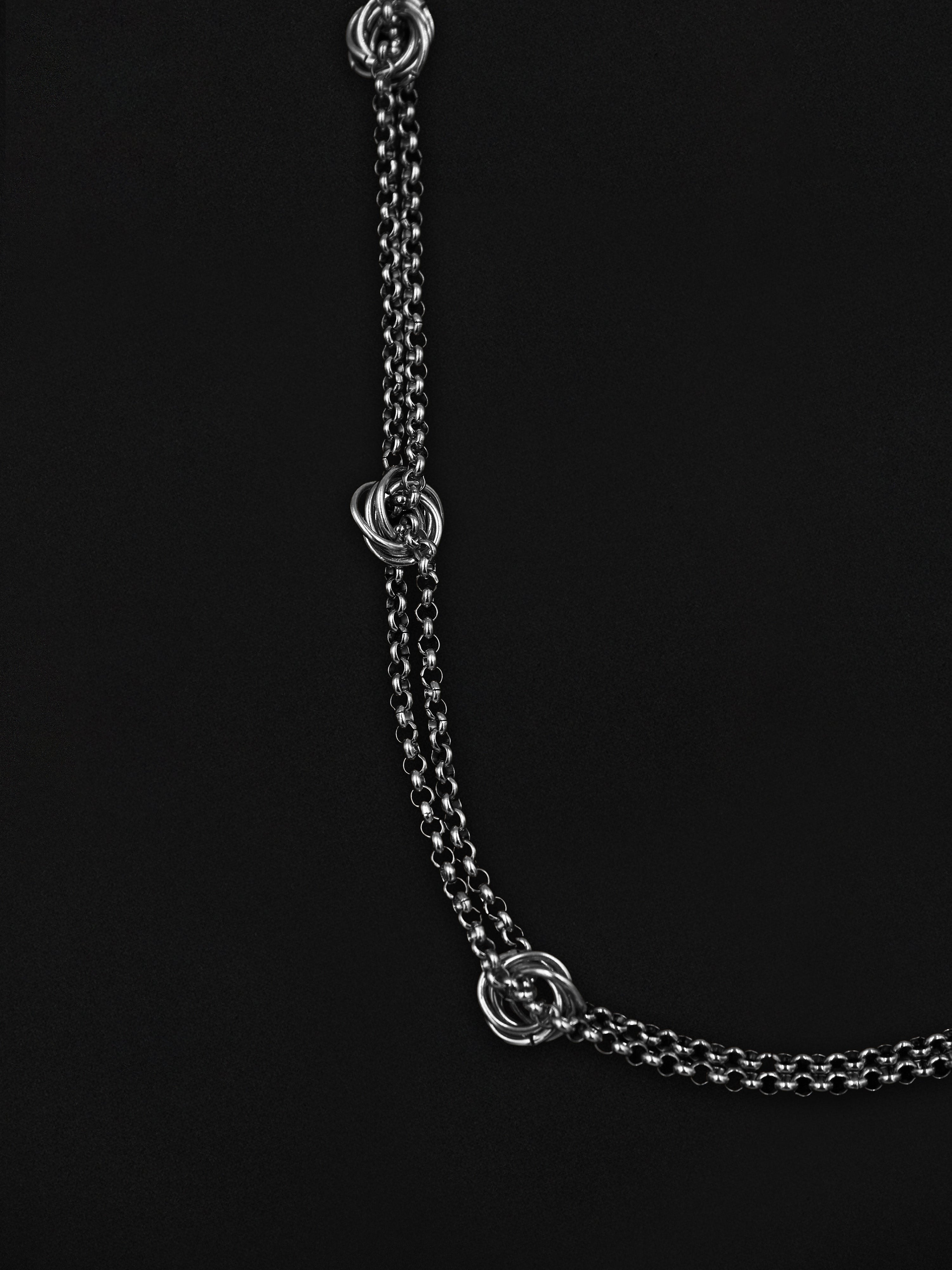 Silver chain necklace on a black background