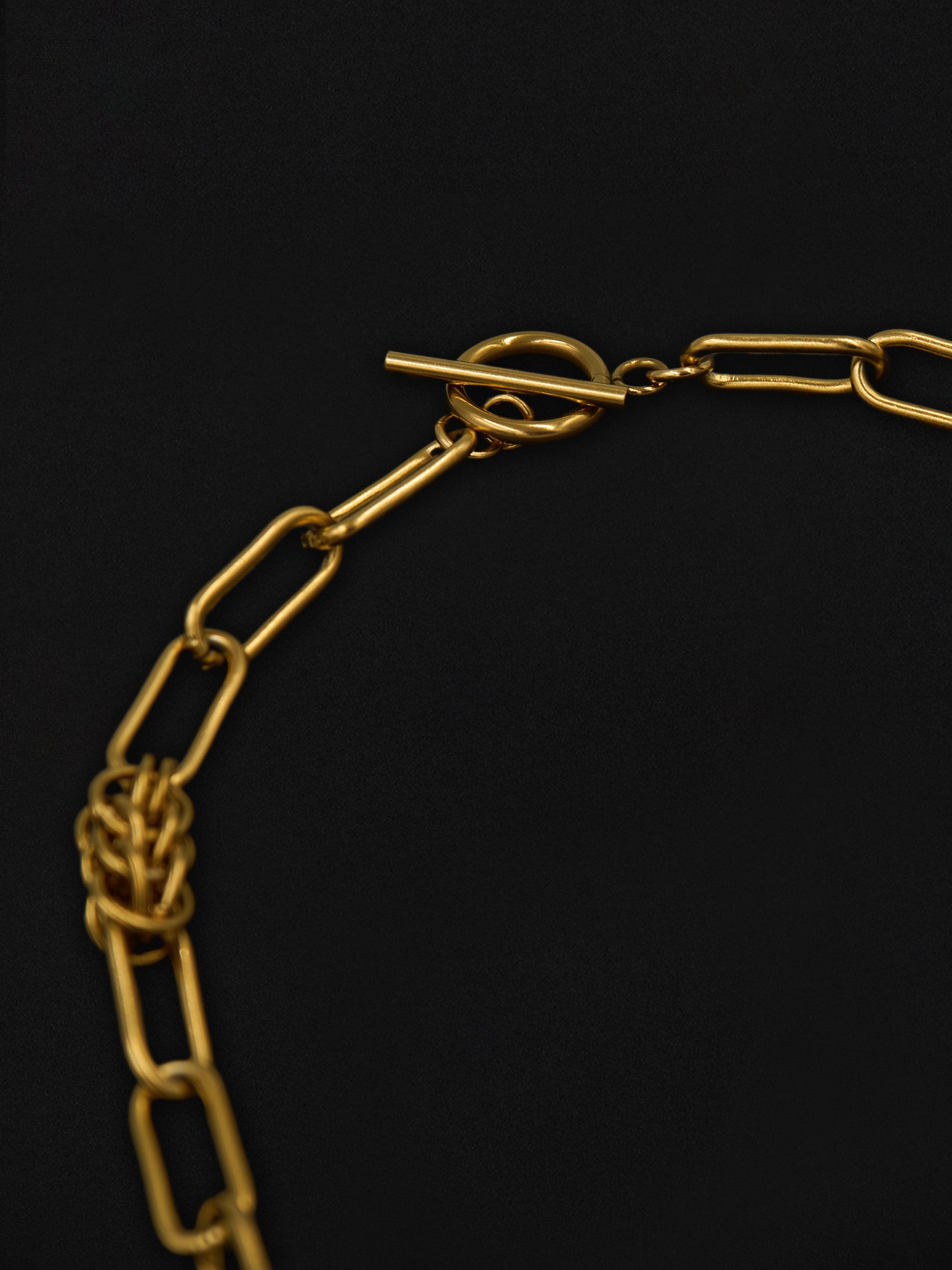 Gold chain necklace on a black background
