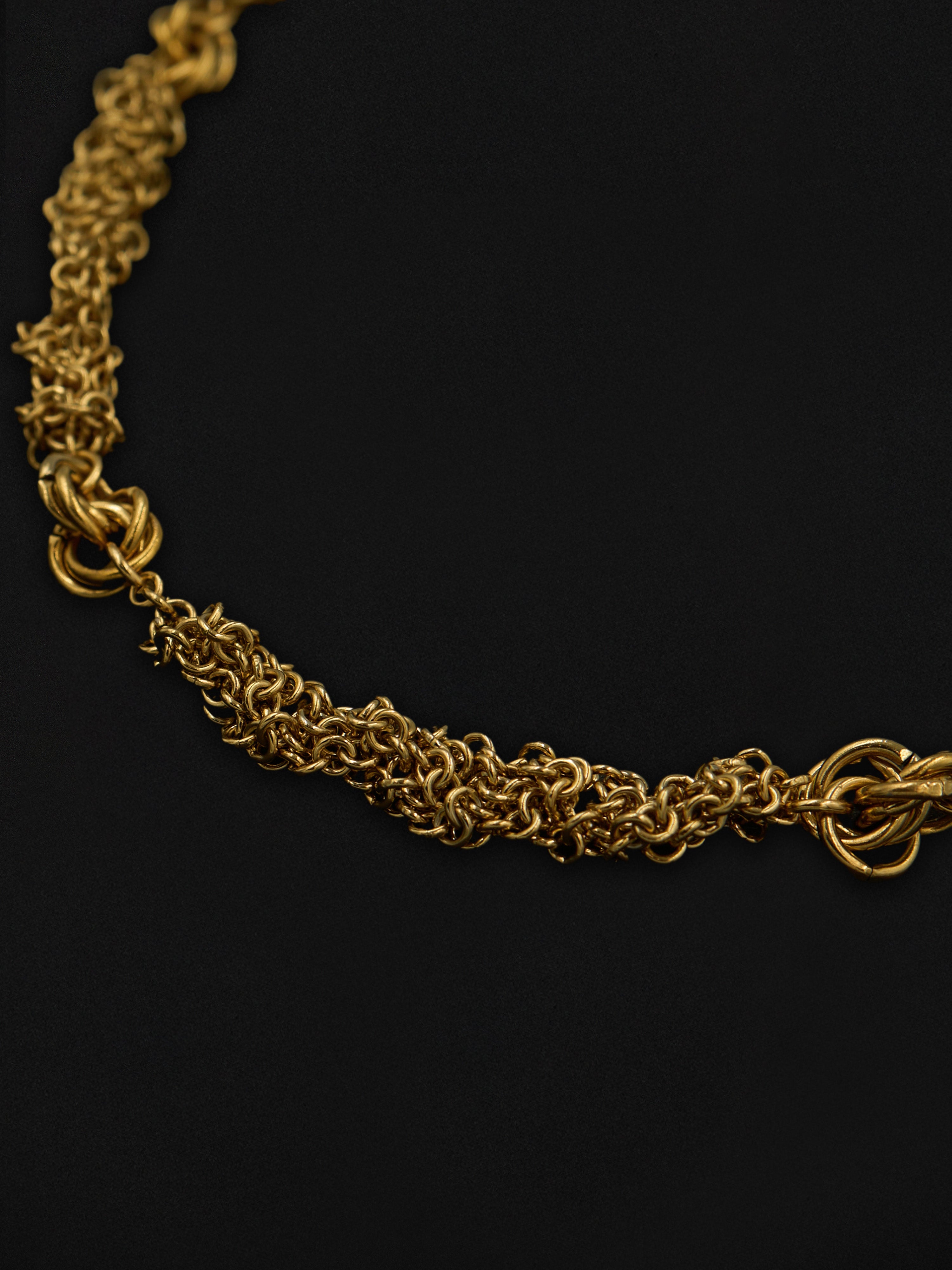 Gold chain necklace on a black background