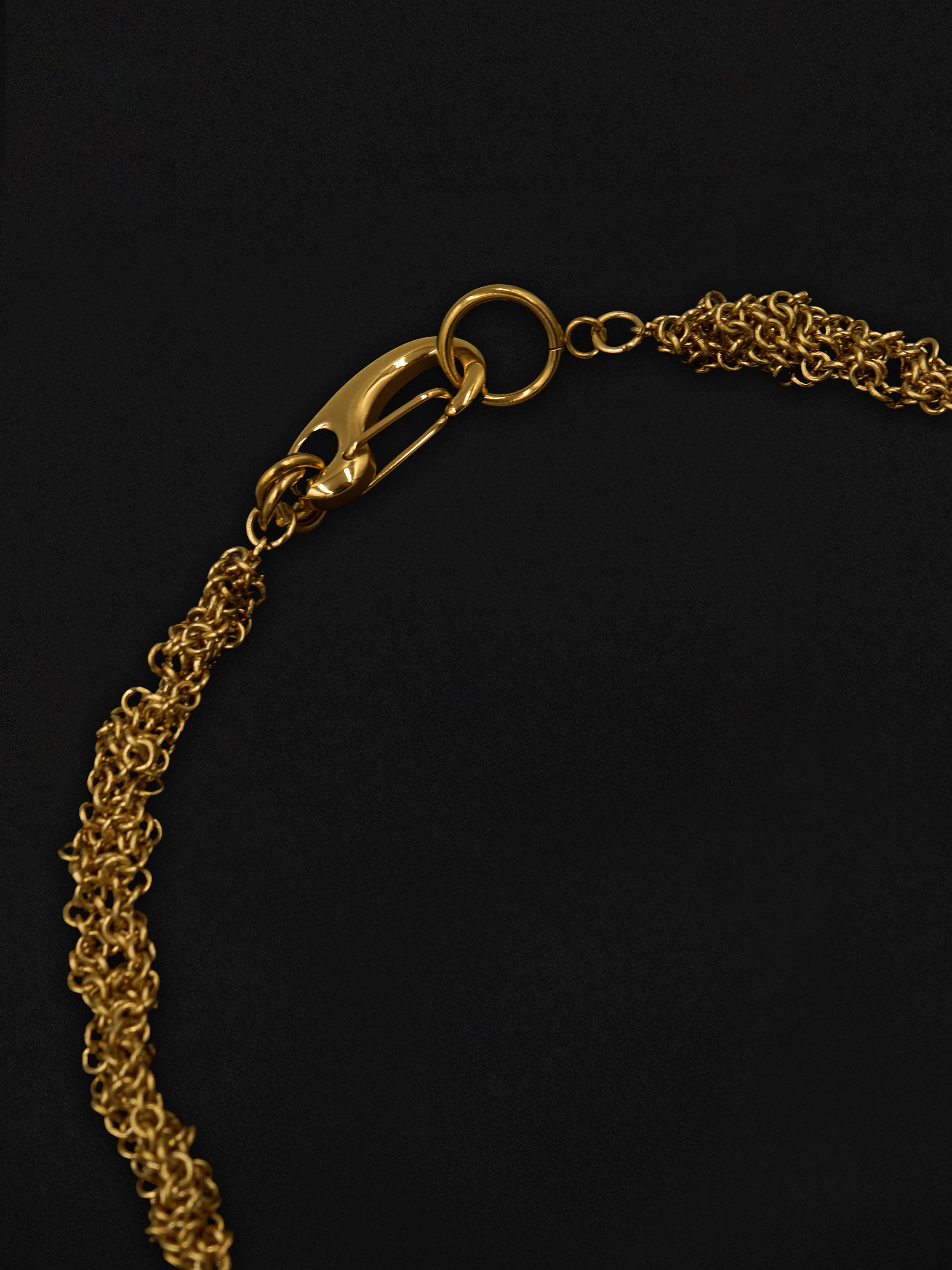 Gold chain necklace on a black background
