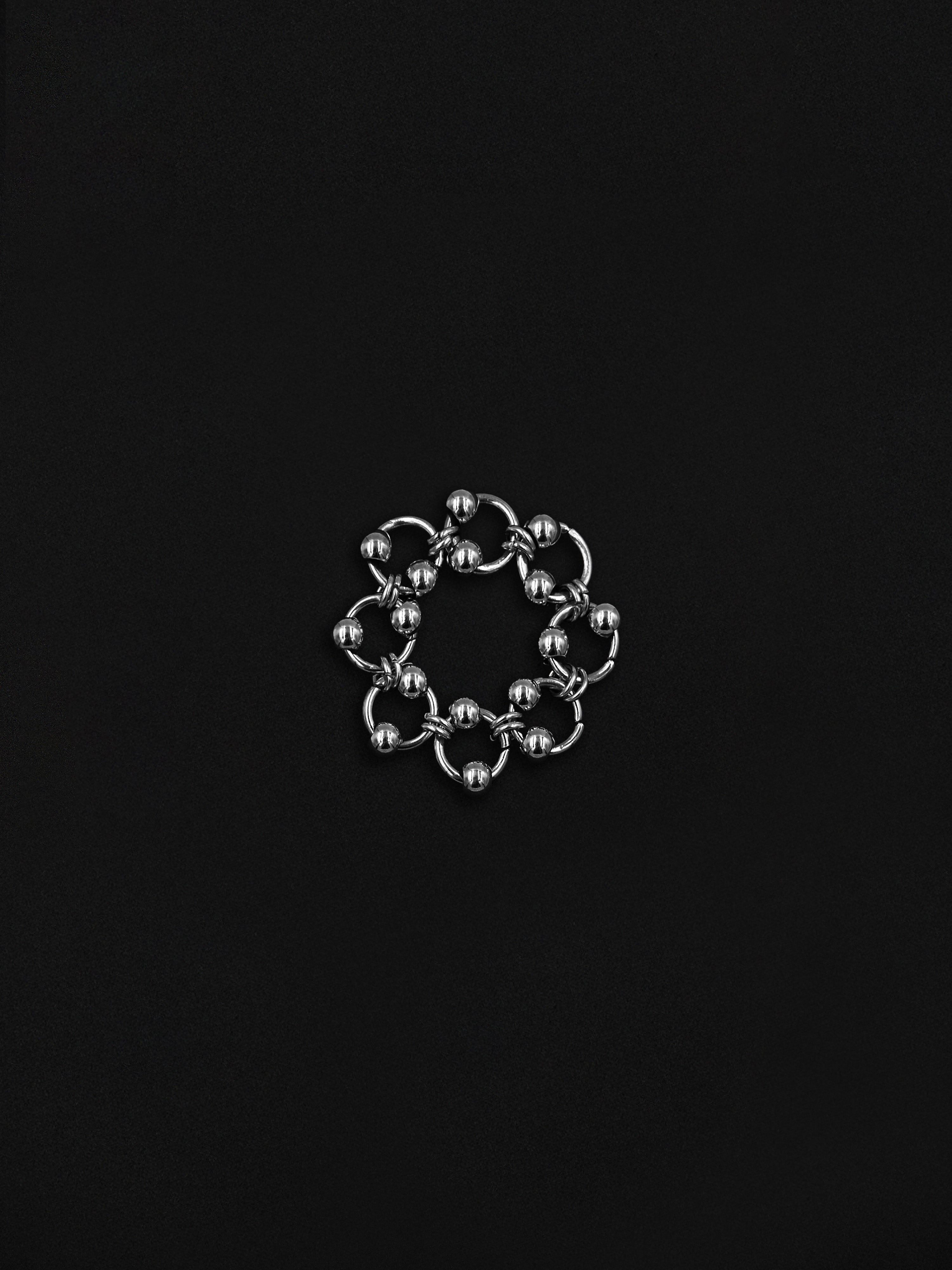 Silver chain ring on a black background